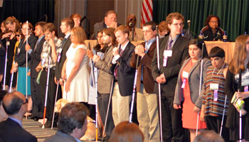 Scholarship winners stand in a line together in front of the convention.